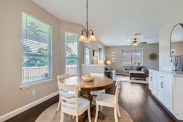 2106 Valerian Trl, Round Rock, TX 78665 - dining room with baseboards, dark wood-style flooring, a ceiling fan, and a chandelier