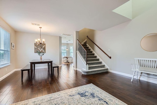 2106 Valerian Trl, Round Rock, TX 78665 - dining area featuring stairway, dark wood finished floors, a chandelier, and baseboards