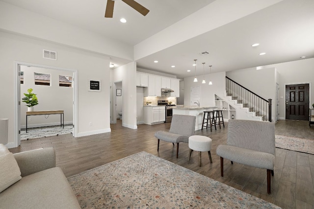 1051 Kenney Fort Xing Unit 73, Round Rock, TX 78665 - living area featuring wood finished floors, a ceiling fan, baseboards, and recessed lighting
