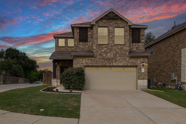 1051 Kenney Fort Xing Unit 73, Round Rock, TX 78665 - traditional-style home with an attached garage, driveway, a lawn, and central air condition unit