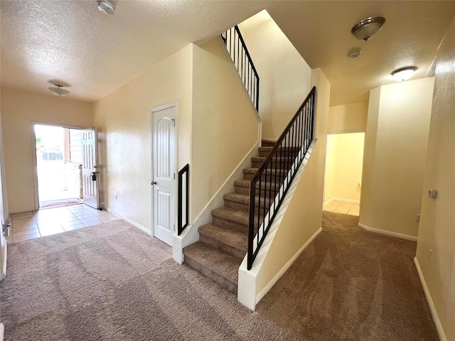 1404 Elbe St, Pflugerville, TX 78660 - stairway with a textured ceiling and carpet flooring