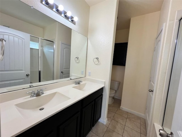 1404 Elbe St, Pflugerville, TX 78660 - bathroom featuring double vanity, tile patterned flooring, and a shower with door