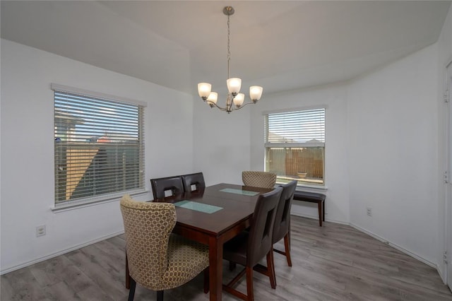 dining room with an inviting chandelier, wood finished floors, and baseboards