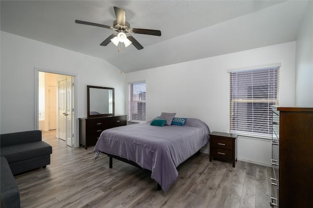 bedroom with wood finished floors, ceiling fan, and vaulted ceiling
