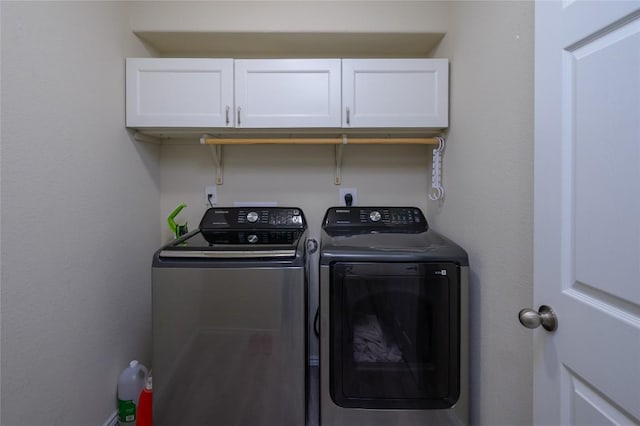 laundry room with cabinet space and washing machine and dryer