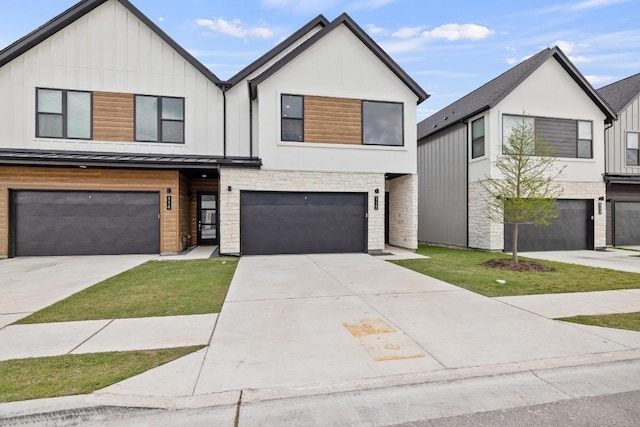 590 Old Mill Rd Unit 113, Cedar Park, TX 78613 - view of front facade featuring stone siding, board and batten siding, a garage, and driveway