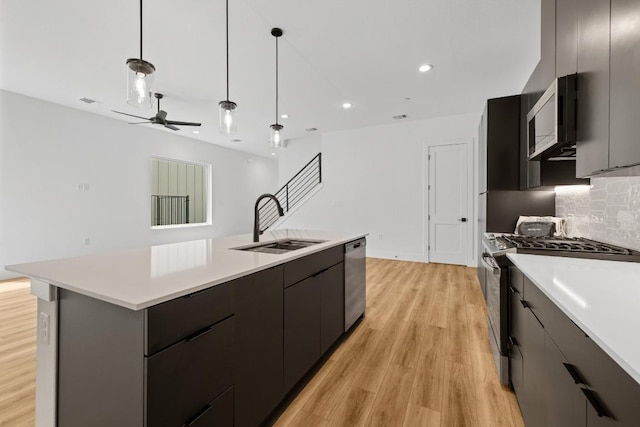 590 Old Mill Rd Unit 113, Cedar Park, TX 78613 - kitchen with appliances with stainless steel finishes, a sink, light countertops, light wood-style flooring, and recessed lighting
