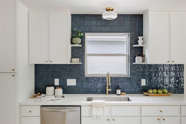 kitchen featuring open shelves, stainless steel dishwasher, a sink, and white cabinetry