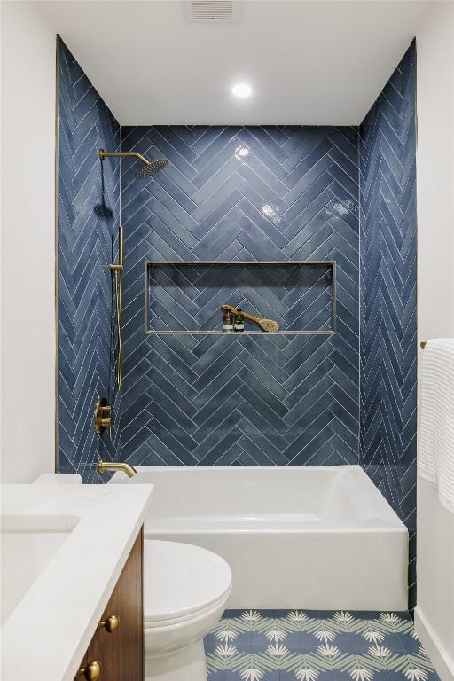 bathroom featuring shower / bathtub combination, vanity, and toilet