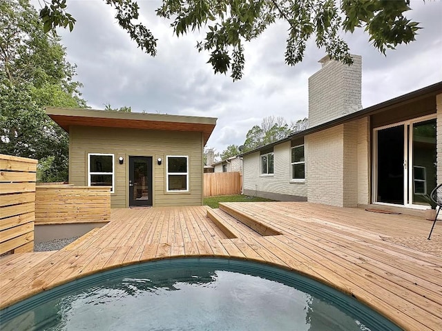 view of pool with a deck and fence