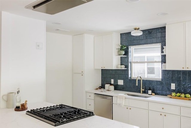 kitchen featuring a sink, decorative backsplash, stainless steel dishwasher, and open shelves