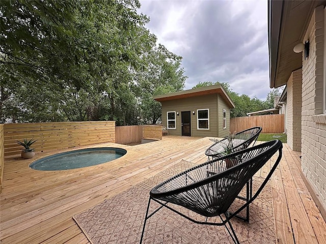 wooden deck featuring fence and a hot tub