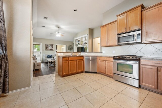 kitchen featuring visible vents, decorative backsplash, a peninsula, a ceiling fan, and appliances with stainless steel finishes