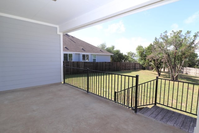 view of patio with a wooden deck and a fenced backyard