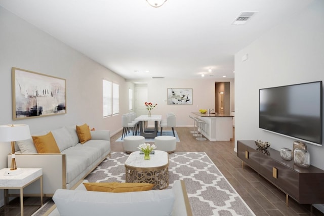 living room featuring recessed lighting, wood finish floors, visible vents, and baseboards