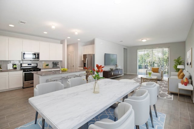 dining space featuring recessed lighting, visible vents, and light wood-style flooring