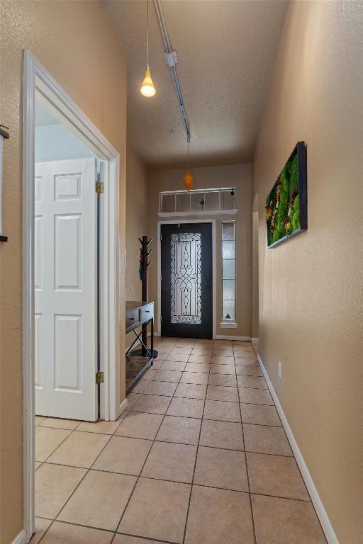 entryway with light tile patterned flooring