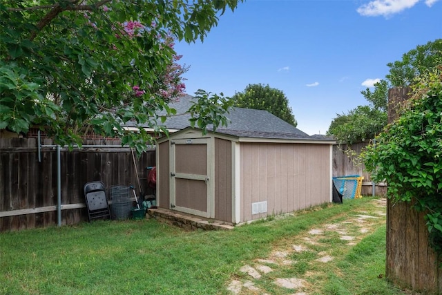 view of shed with a fenced backyard