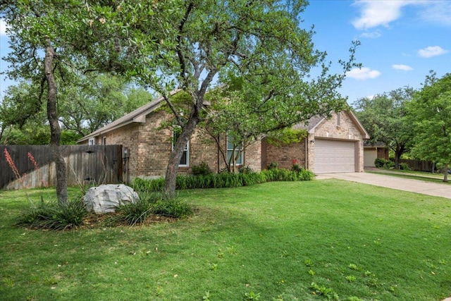 view of front facade featuring brick siding, a front lawn, fence, and concrete driveway