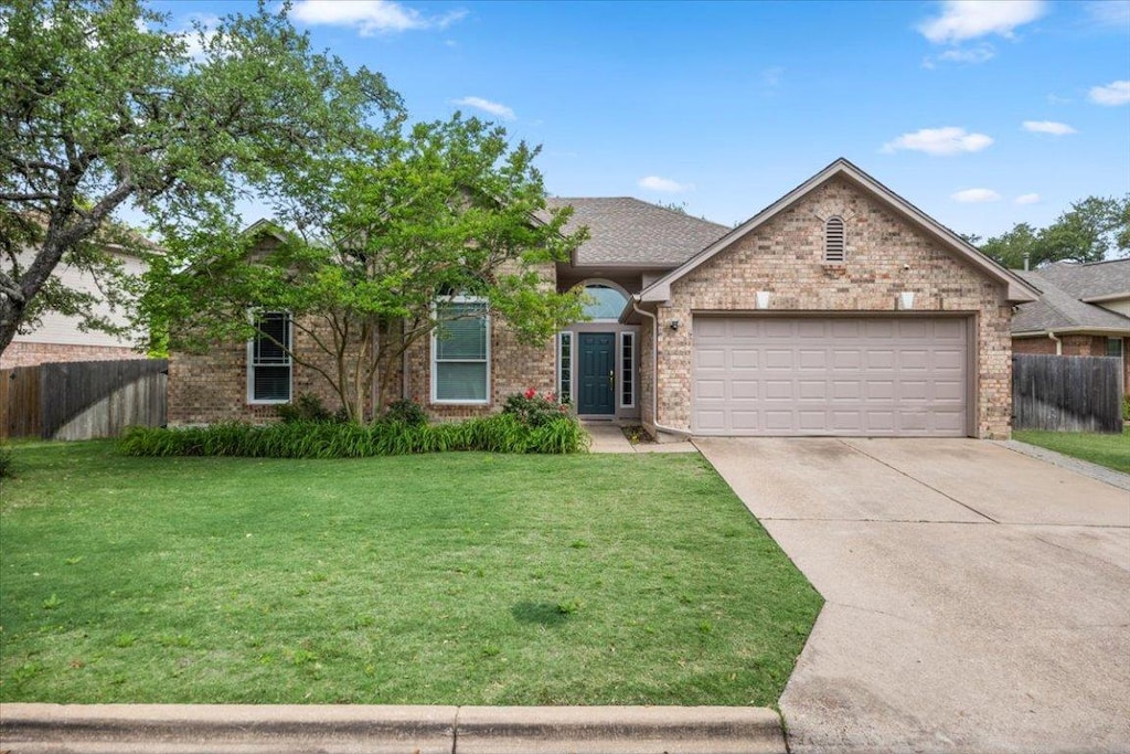 6850 Auckland Dr, Austin, TX 78749 - view of front of home featuring fence, a front lawn, brick siding, a garage, and concrete driveway