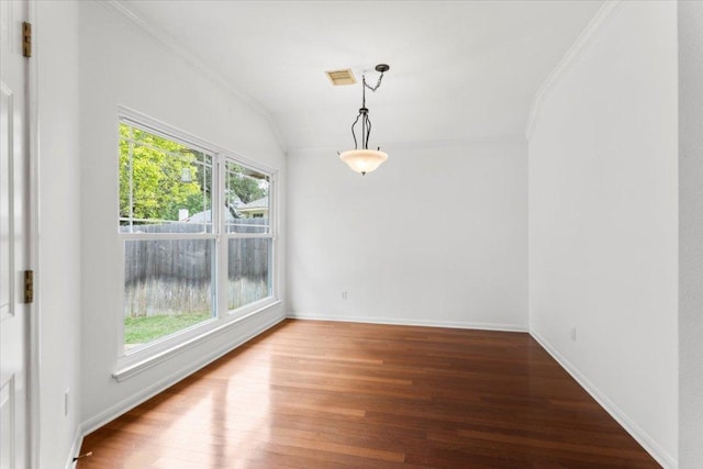 unfurnished dining area featuring plenty of natural light, ornamental molding, and wood finished floors