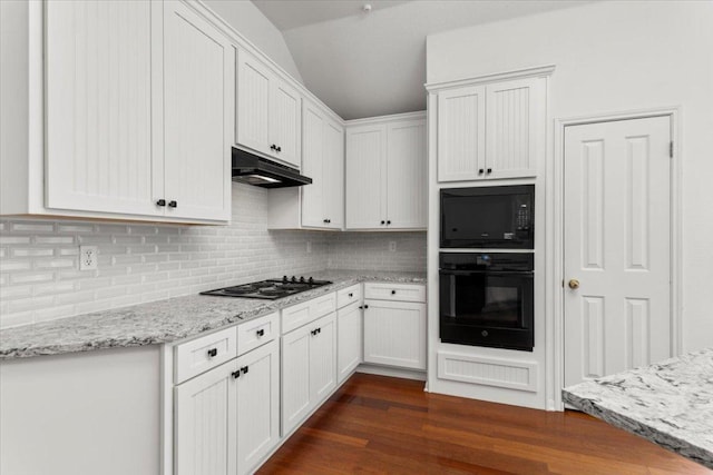 kitchen featuring decorative backsplash, white cabinetry, under cabinet range hood, and black appliances
