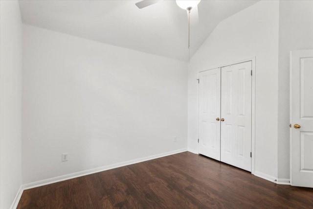unfurnished bedroom with baseboards, wood finished floors, lofted ceiling, and a closet