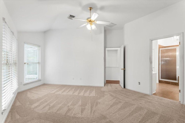 unfurnished bedroom with ceiling fan, visible vents, baseboards, carpet, and ensuite bath
