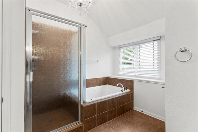 bathroom featuring tile patterned flooring, a shower stall, a garden tub, and lofted ceiling