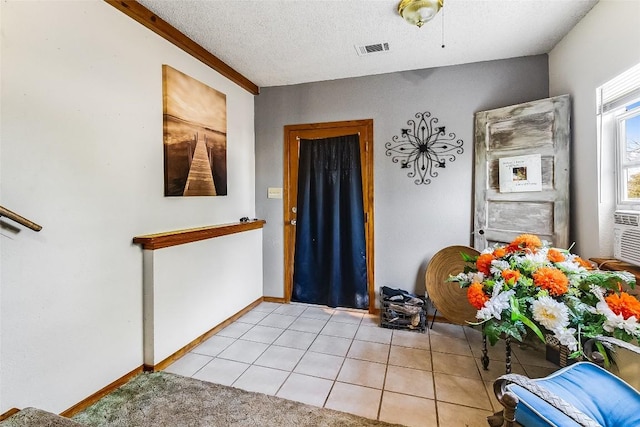 288 Ballard St, Tow, TX 78672 - entryway featuring a textured ceiling, visible vents, light tile patterned floors, baseboards, and cooling unit
