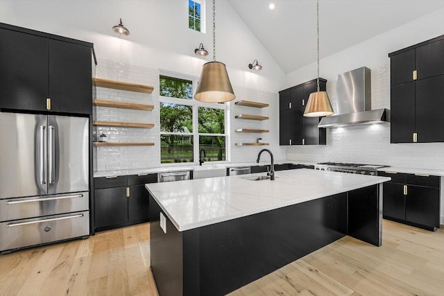 1105 Lipan Trl, Austin, TX 78733 - kitchen with dark cabinetry, appliances with stainless steel finishes, open shelves, wall chimney exhaust hood, and high vaulted ceiling