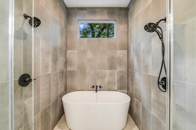 1105 Lipan Trl, Austin, TX 78733 - bathroom featuring tile walls, a tile shower, and a freestanding tub