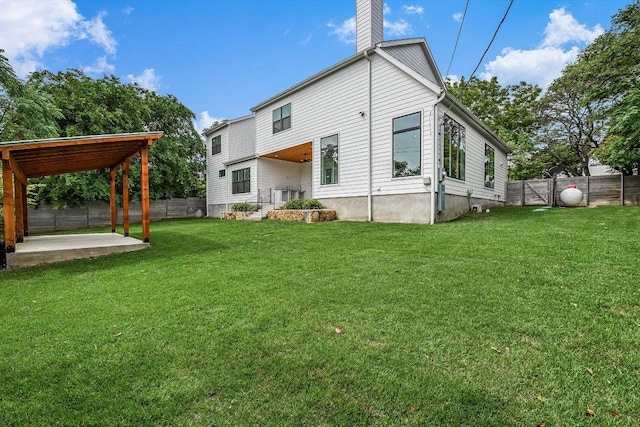 1105 Lipan Trl, Austin, TX 78733 - rear view of house with a fenced backyard, a chimney, and a patio