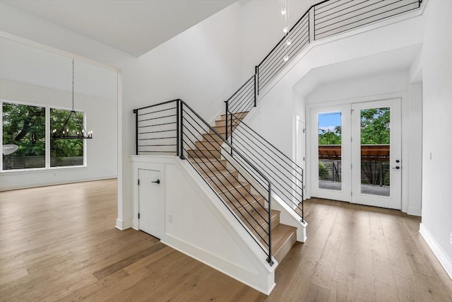 1105 Lipan Trl, Austin, TX 78733 - stairway with plenty of natural light, a chandelier, and wood finished floors