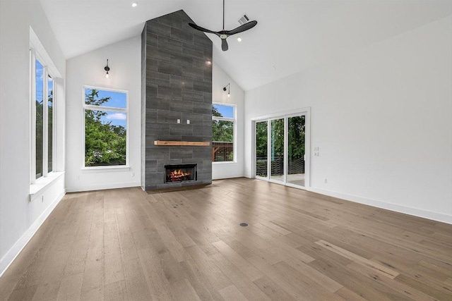 1105 Lipan Trl, Austin, TX 78733 - unfurnished living room featuring high vaulted ceiling, a large fireplace, wood finished floors, and ceiling fan