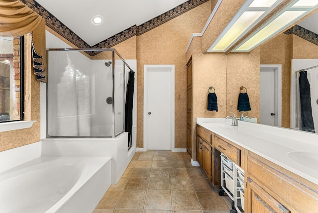 bathroom featuring a sink, double vanity, a stall shower, and a garden tub