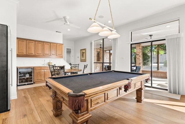 rec room with beverage cooler, light wood-style floors, ceiling fan, billiards, and wet bar