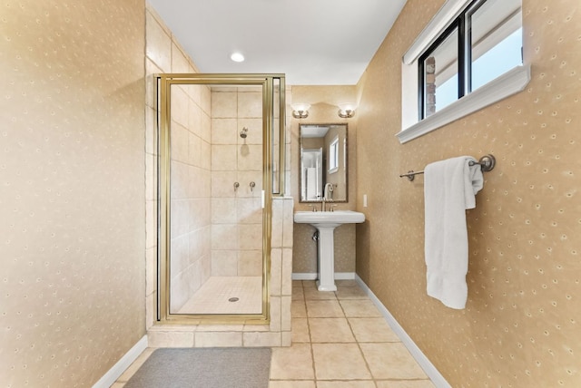bathroom with tile patterned floors, a shower stall, and baseboards