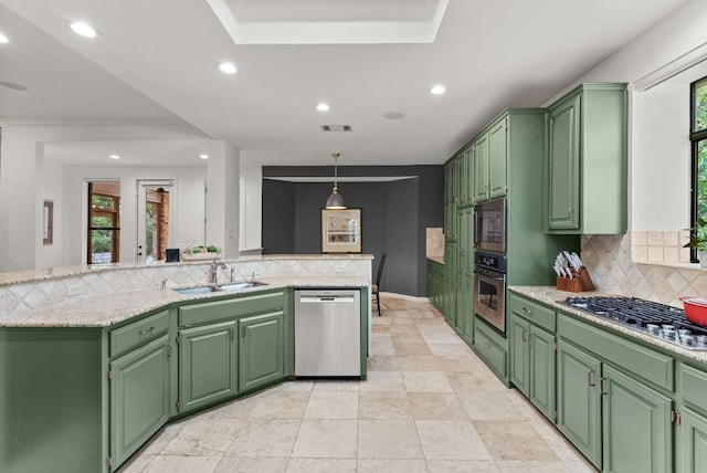 kitchen with a sink, decorative backsplash, a wealth of natural light, and stainless steel appliances