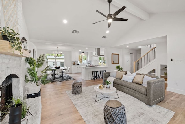 living room with visible vents, stairway, high vaulted ceiling, and beamed ceiling