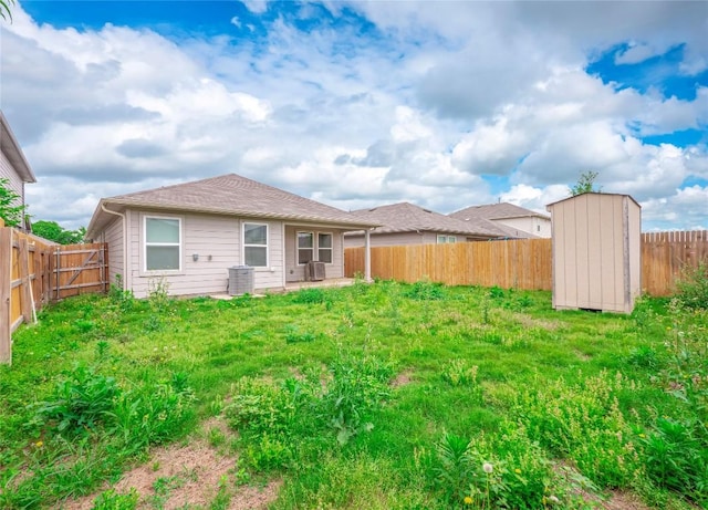 205 Granary Dr, Kyle, TX 78640 - back of property featuring a storage shed, an outdoor structure, a fenced backyard, and a patio