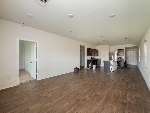 205 Granary Dr, Kyle, TX 78640 - unfurnished living room featuring baseboards, dark wood-type flooring, and visible vents