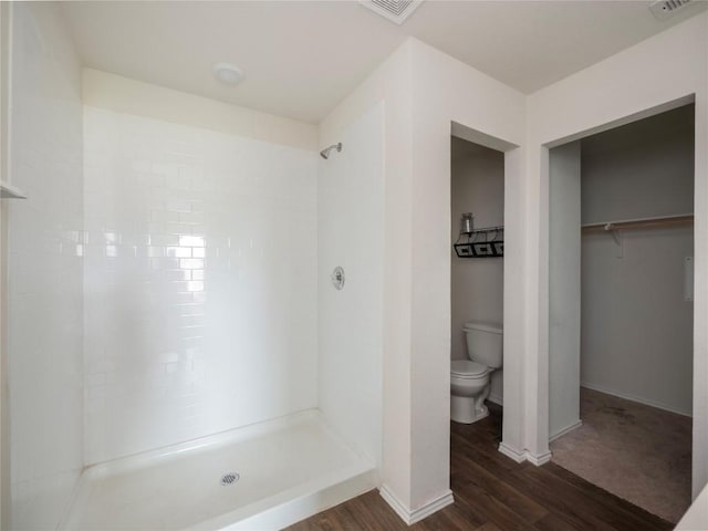 205 Granary Dr, Kyle, TX 78640 - bathroom with a walk in shower, toilet, baseboards, wood finished floors, and visible vents