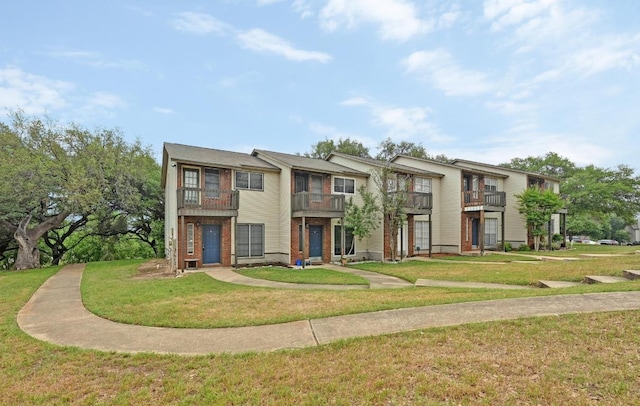 1815 River Crossing Cir Unit A, Austin, TX 78741 - multi unit property featuring a balcony, a front yard, and brick siding