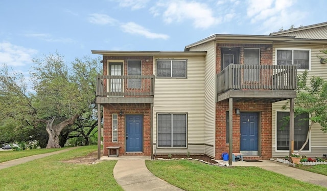 1815 River Crossing Cir Unit A, Austin, TX 78741 - multi unit property with a balcony, brick siding, and a front yard