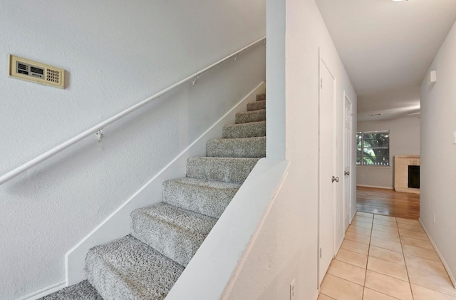 1815 River Crossing Cir Unit A, Austin, TX 78741 - stairs featuring tile patterned floors and a fireplace