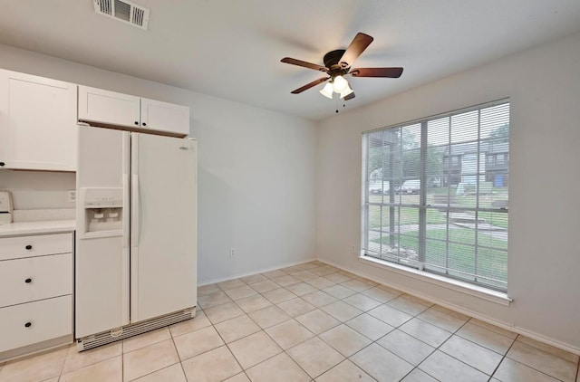1815 River Crossing Cir Unit A, Austin, TX 78741 - kitchen featuring white fridge with ice dispenser, a ceiling fan, white cabinetry, light countertops, and light tile patterned flooring