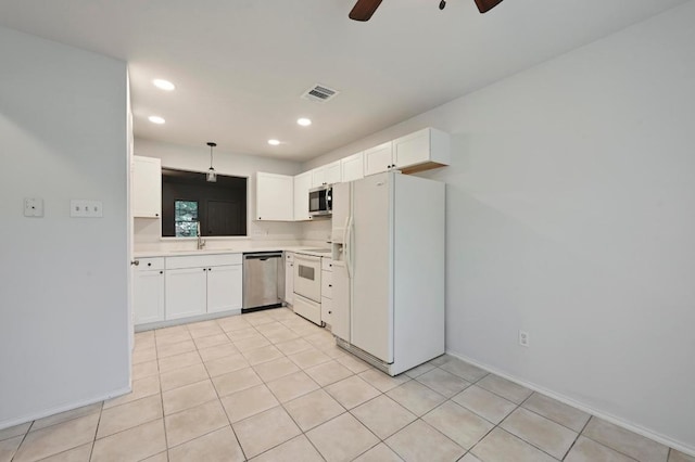 1815 River Crossing Cir Unit A, Austin, TX 78741 - kitchen with stainless steel appliances, white cabinets, ceiling fan, light countertops, and recessed lighting