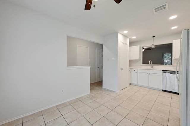 1815 River Crossing Cir Unit A, Austin, TX 78741 - kitchen featuring stainless steel dishwasher, ceiling fan, a sink, white cabinets, and freestanding refrigerator