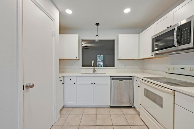 1815 River Crossing Cir Unit A, Austin, TX 78741 - kitchen with stainless steel appliances, a sink, light tile patterned flooring, light countertops, and white cabinets